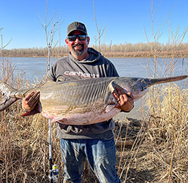 Man holding large paddlefish