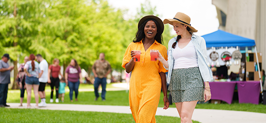 Two women walking at a festival in Houma, Louisiana.