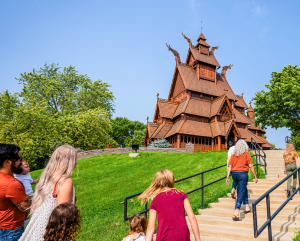 people walking up stairs to see large building