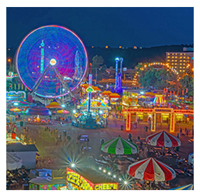 festival at night with rides lit up