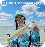 Girl holding a fish on a sunny day