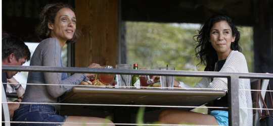 Two women enjoy waterfront dining at The Chimes in Covington.
