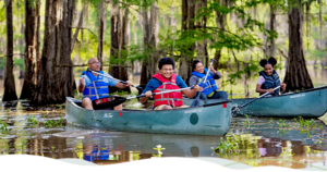 A family of four paddle along Lake Bistineau.