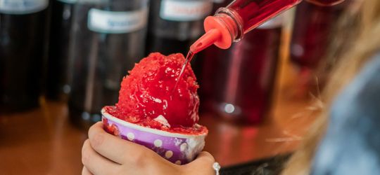 A close-up image of a red snoball being made. 