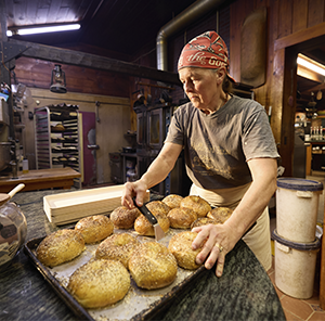 baker preparing bread behind the counter at a bake shop 