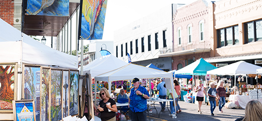 A crowd strolls an art festival