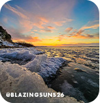 Sunset over an icy body of water, with overlay text that reads @blazingsuns26