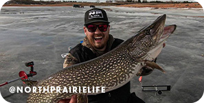Smiling man holding up a large caught fish while on a body of water in a boat, with overlay text that reads @northprairielife