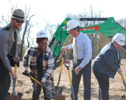 People with shovels (including 74th Governor John Carney and HCA Director Suzanne Savery) break ground during a ceremony for a new visitors center at the John Dickinson Plantation.