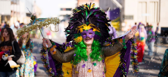 A woman dressed in Mardi Gras accessories. 