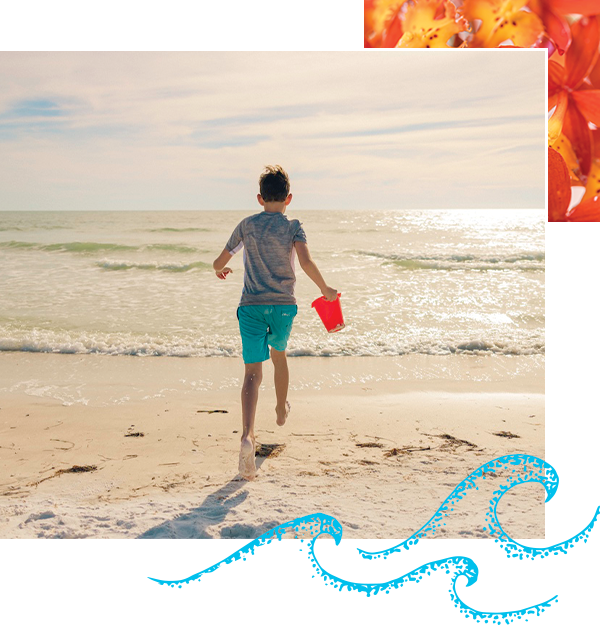 young boy running into the ocean with sand pail in siesta
