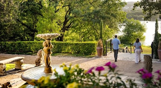 A couple strolls the grounds of UMLAUF Sculpture Garden + Museum in Austin, Texas