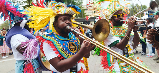 A performer plays music at Festival International de Louisiane.