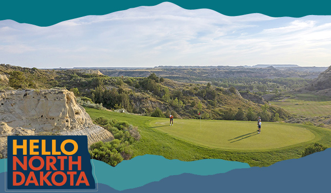 Wide overhead view of a golf course tucked into rock formations, with overlay text that reads: Hello North Dakota