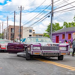 A purple custom car leads a Juneteenth parade in Austin, Texas