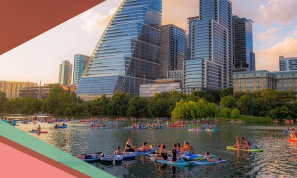 Kayakers on Lady Bird Lake with downtown Austin skyscrapers in the background