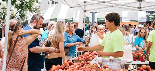 Patrons shop for peaches in Ruston.