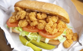 A po'boy overflowing with crispy fried shrimp.