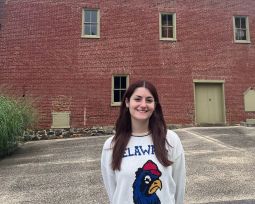 Annabella Cerrone stands out front of a historic building	