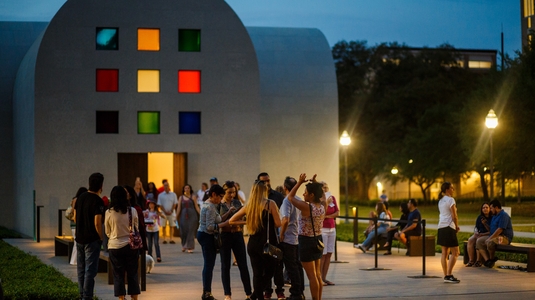 Event attendees gather outside a colorful venue in Austin, Texas