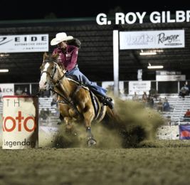 women in cowboy hat riding at a rodeo 