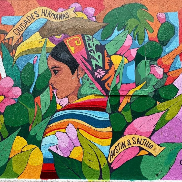Brightly colored Sisterhood of Two Hearts outdoor mural at the Mexic-Arte Museum in Austin