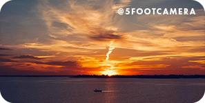 A bright orange sunset over a body of water, with overlay text that reads: @5footcamera