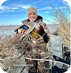 Smiling man holding a hunted bird