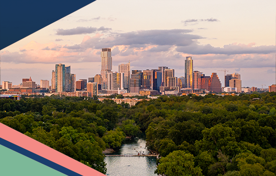 Aerial view of Barton Springs Municipal Pool surrounded by trees in Zilker Park with the Austin skyline in the backyard