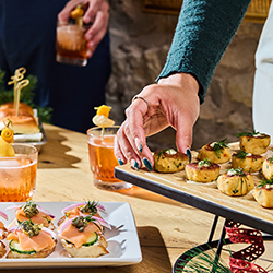 A selection of drinks and small bites on platters at Holey Moley