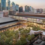 A rendering of the new Austin Convention Center with the city skyline in the background
