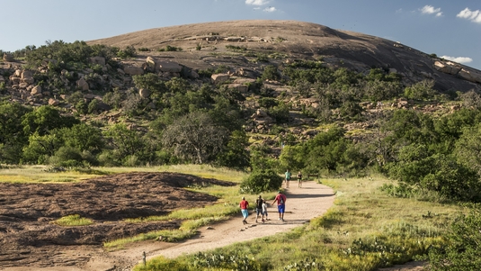 Hikers on a trail in Enchanted Rock State Natural Area in the Texas Hill Country