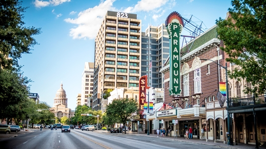 A view of buildings lining Congress Avenue in Austin, Texas, with the state capital at the end