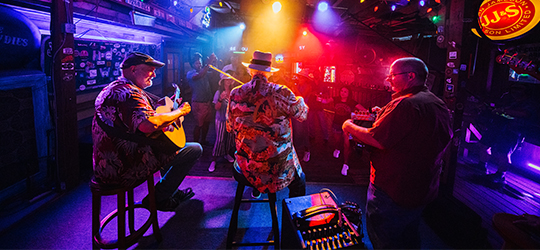 Musicians play in the ambience of Blue Moon Saloon in Lafayette.