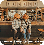 Two people sitting on stools at a bar with jack-o-lanterns on their heads, with overlay text that reads: @brittonfuglsetthedesign