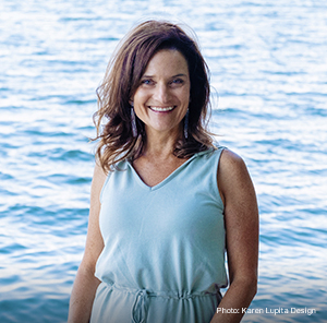 Woman standing in front of water. 