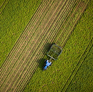 Aerial view of a tracker working the harvest field 