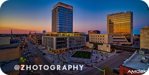 View of city buildings with sunset in the background, with overlay text that reads: @zhotography