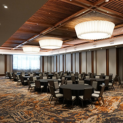 Meeting attendees sit at tables listening to a speaker at AT&T Hotel and Conference Center in Austin, Texas