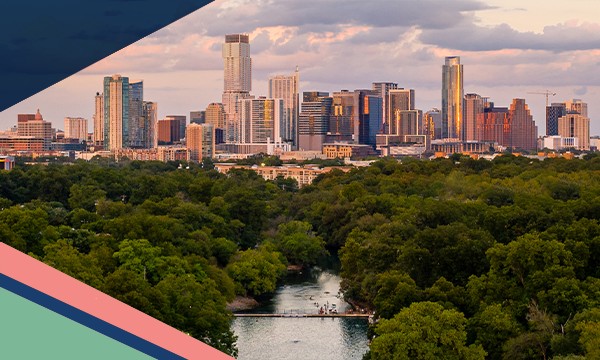 Aerial view of Barton Springs Municipal Pool surrounded by trees in Zilker Park with the Austin skyline in the backyard