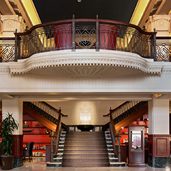 The two-story lobby and staircase inside The Stephen F. Austin Royal Sonesta Hotel in Austin, Texas