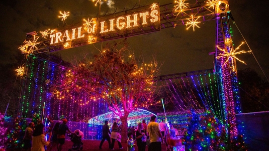 Multicolored holiday lights greet visitors at the entrance to the Austin Trail of Lights