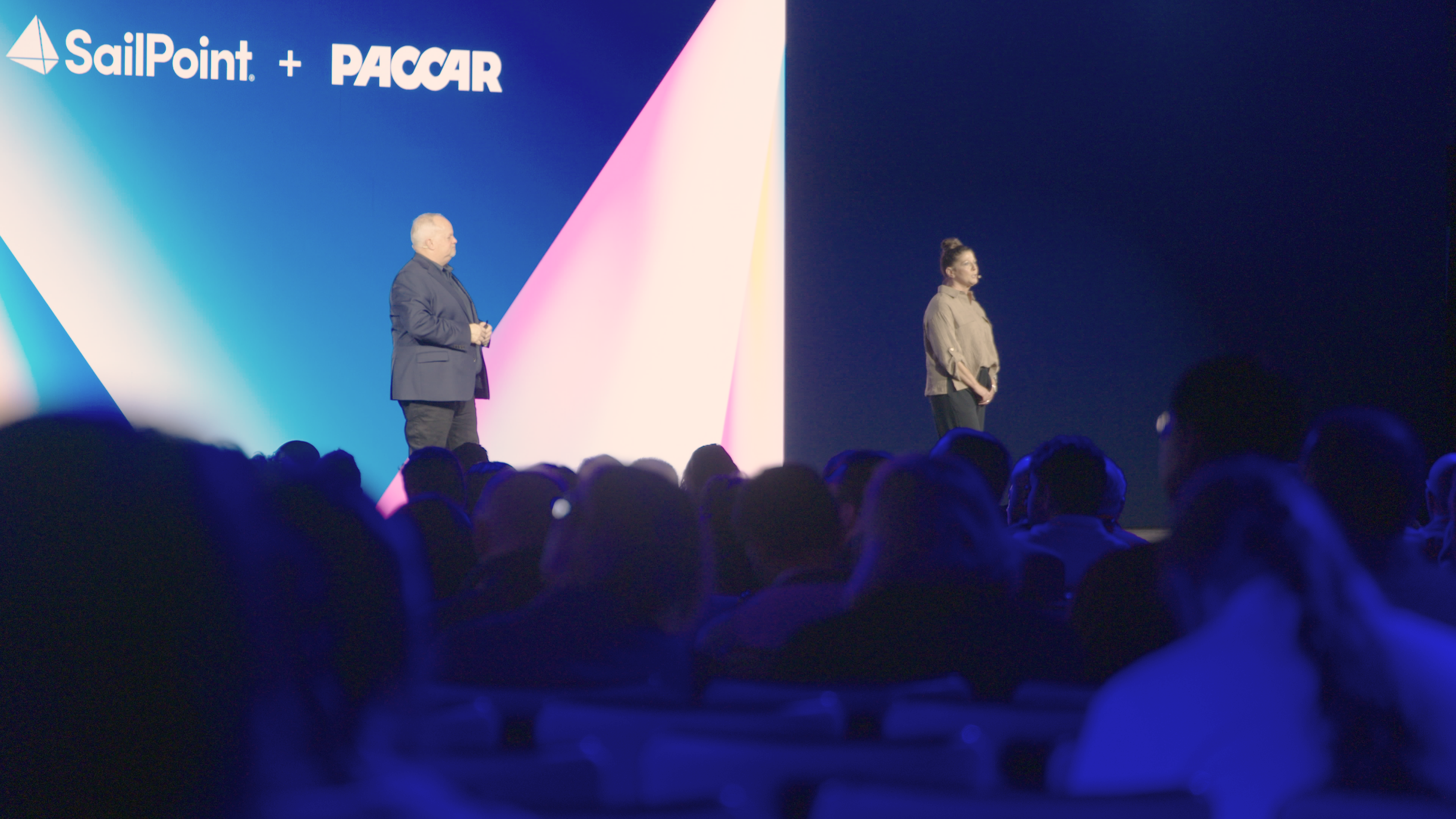 Two speakers onstage during SailPoint Technologies' campus-style Navigate 2025 event in Austin, Texas