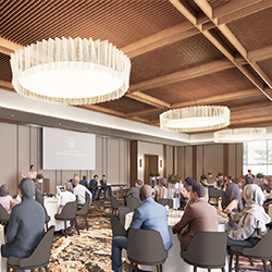 Meeting attendees sit at tables listening to a speaker at AT&T Hotel and Conference Center in Austin, Texas