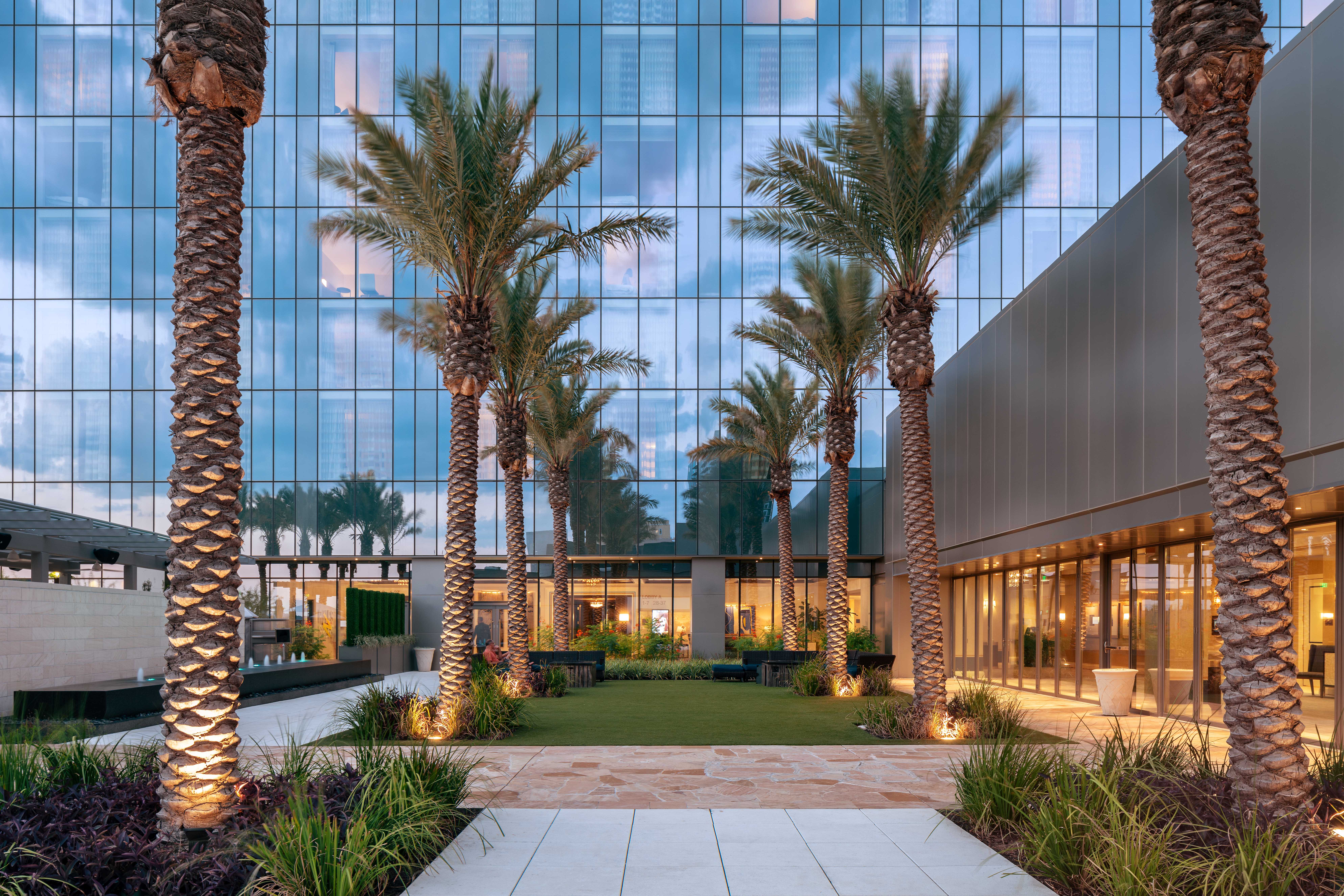 Early evening view of palm trees surround Palm Court at the Fairmont Austin