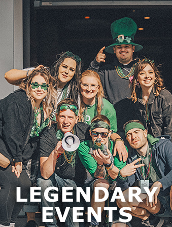 Group of people dressed up in green for a St. Patrick's Day event, with overlay text that reads: Legendary Events
