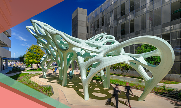People walk under Marc Fornes' light green Meander Wings metal sculpture at Austin-Bergstrom International Airport on a pathway connecting the parking garage to the main terminal