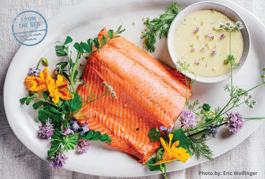 Plated salmon with hollandaise sauce and a spring flower garland 
