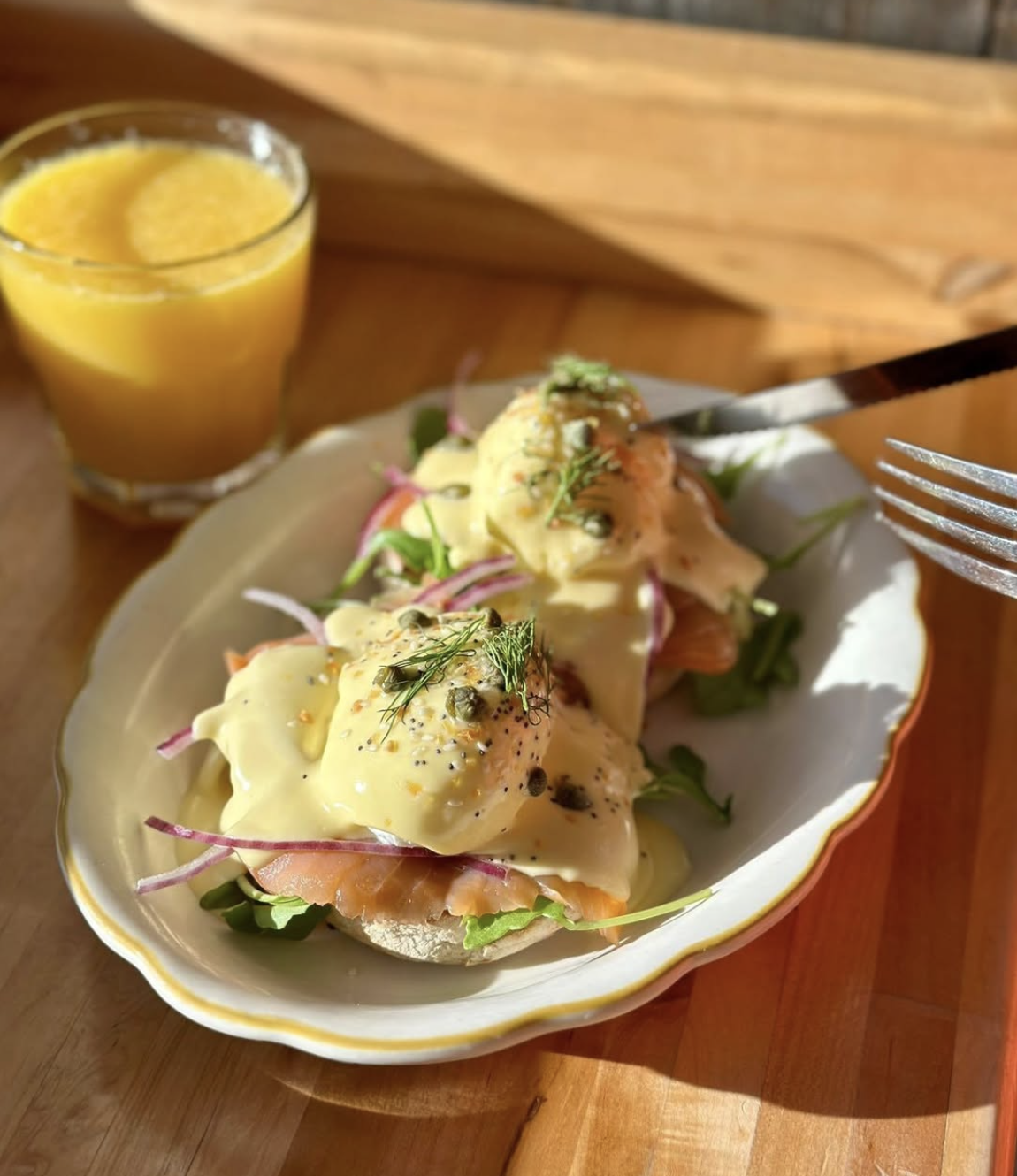 Eggs Benedict with a glass of orange juice