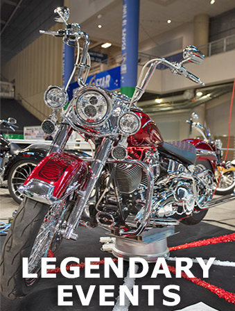 Red and chrome motorcycle on display in a showroom, with overlay text that reads: Legendary Events